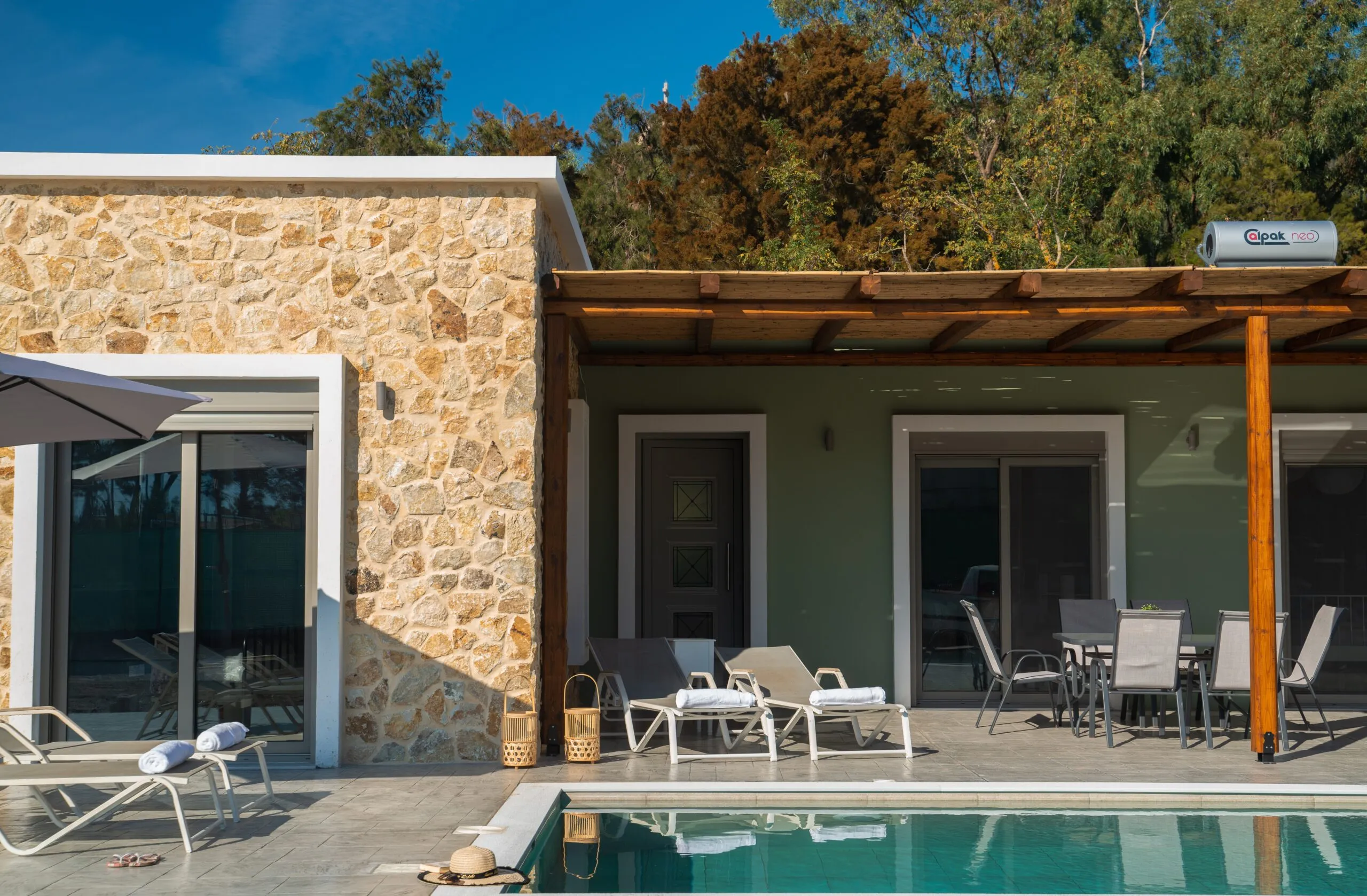 Stone facade with sun loungers by the pool
