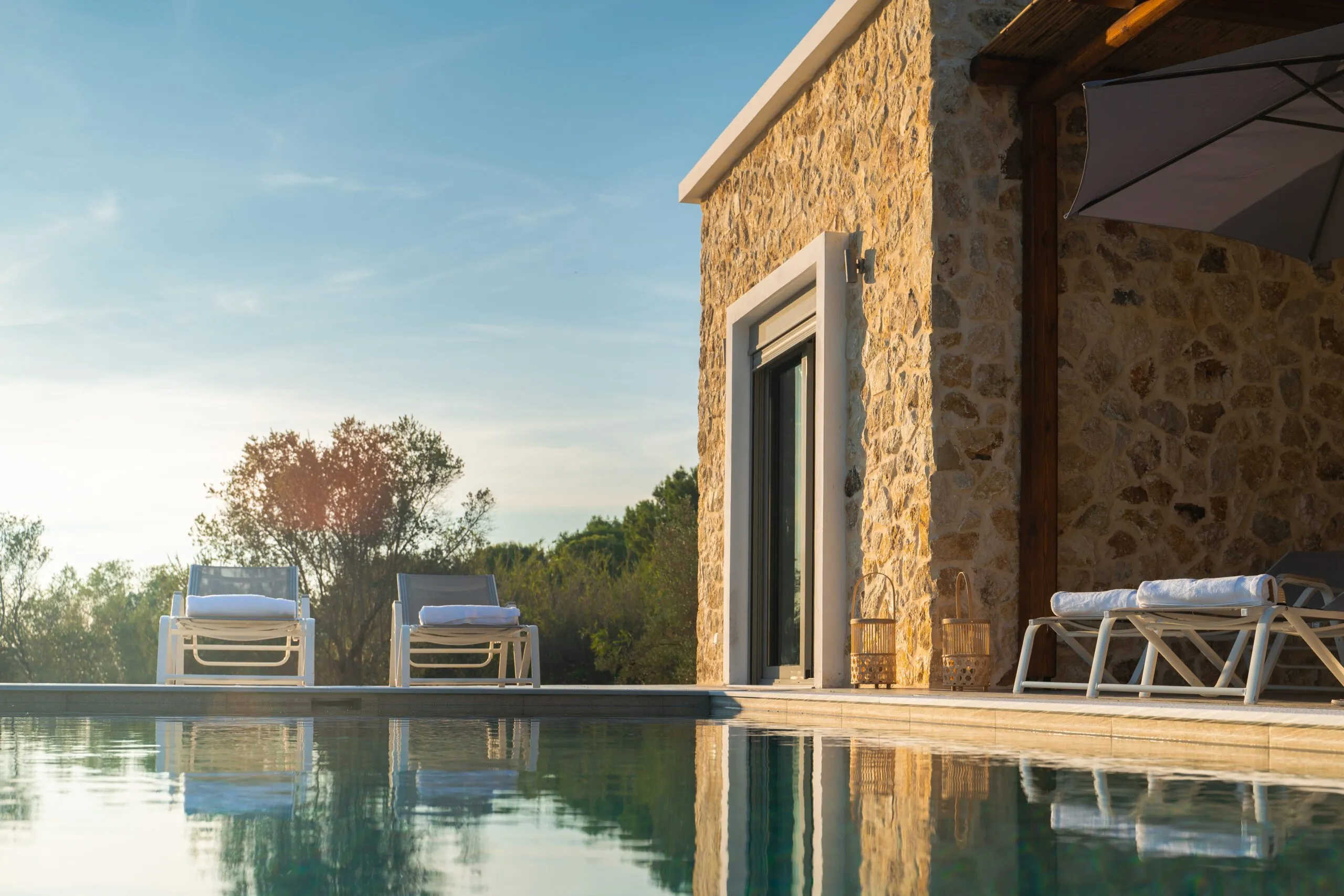 Stone villa and pool at golden hour