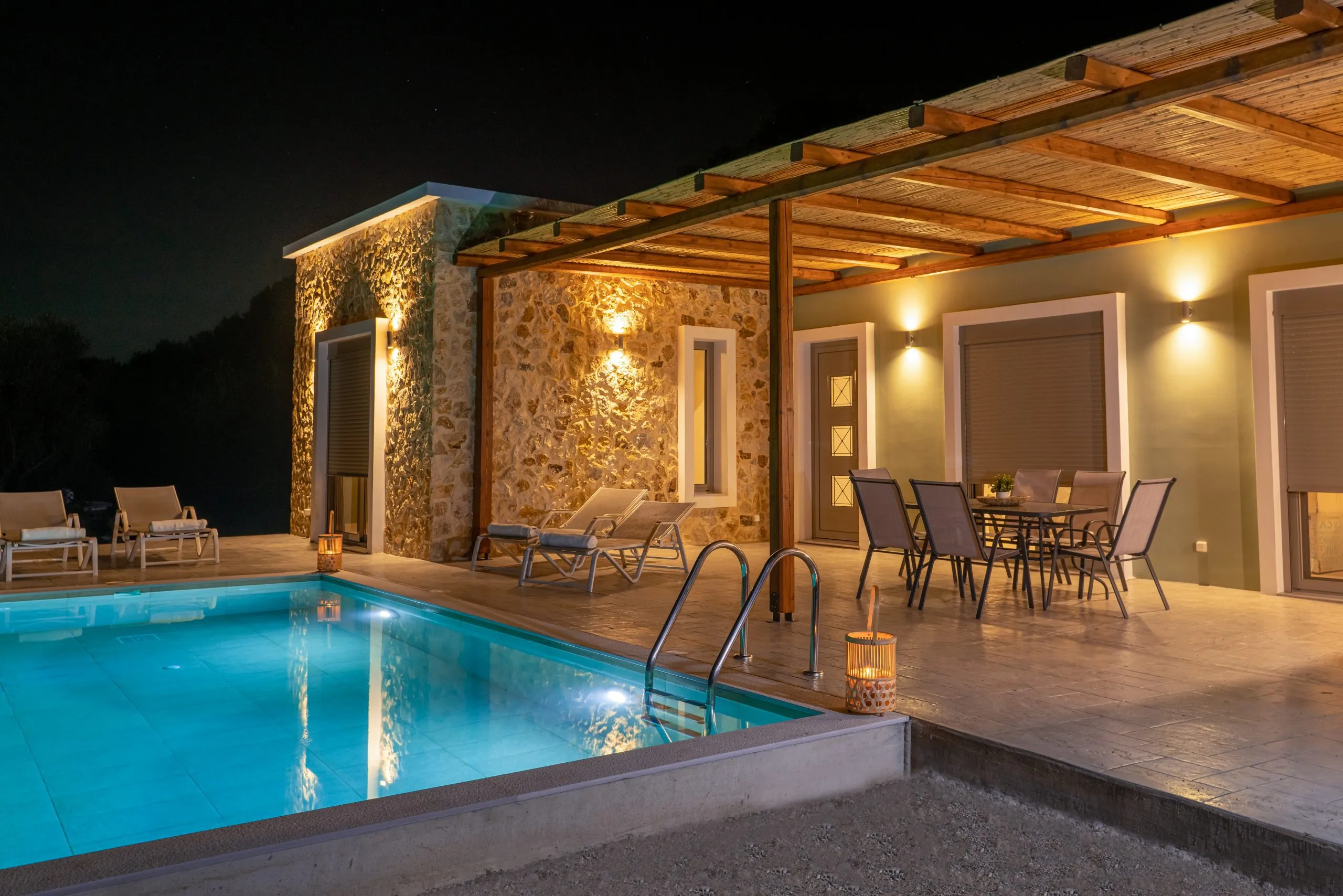 Villa terrace and pool lit up at night