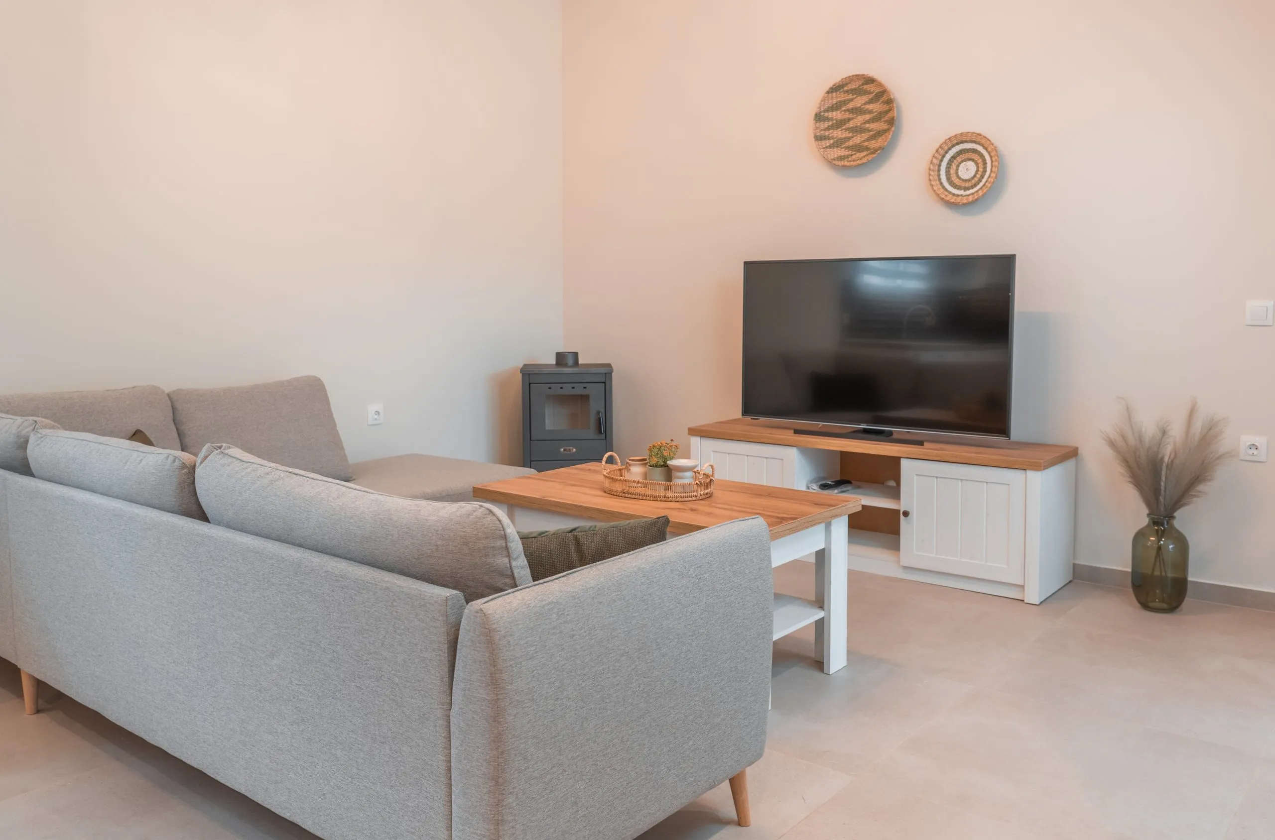 Living room with sofa, TV and wood stove