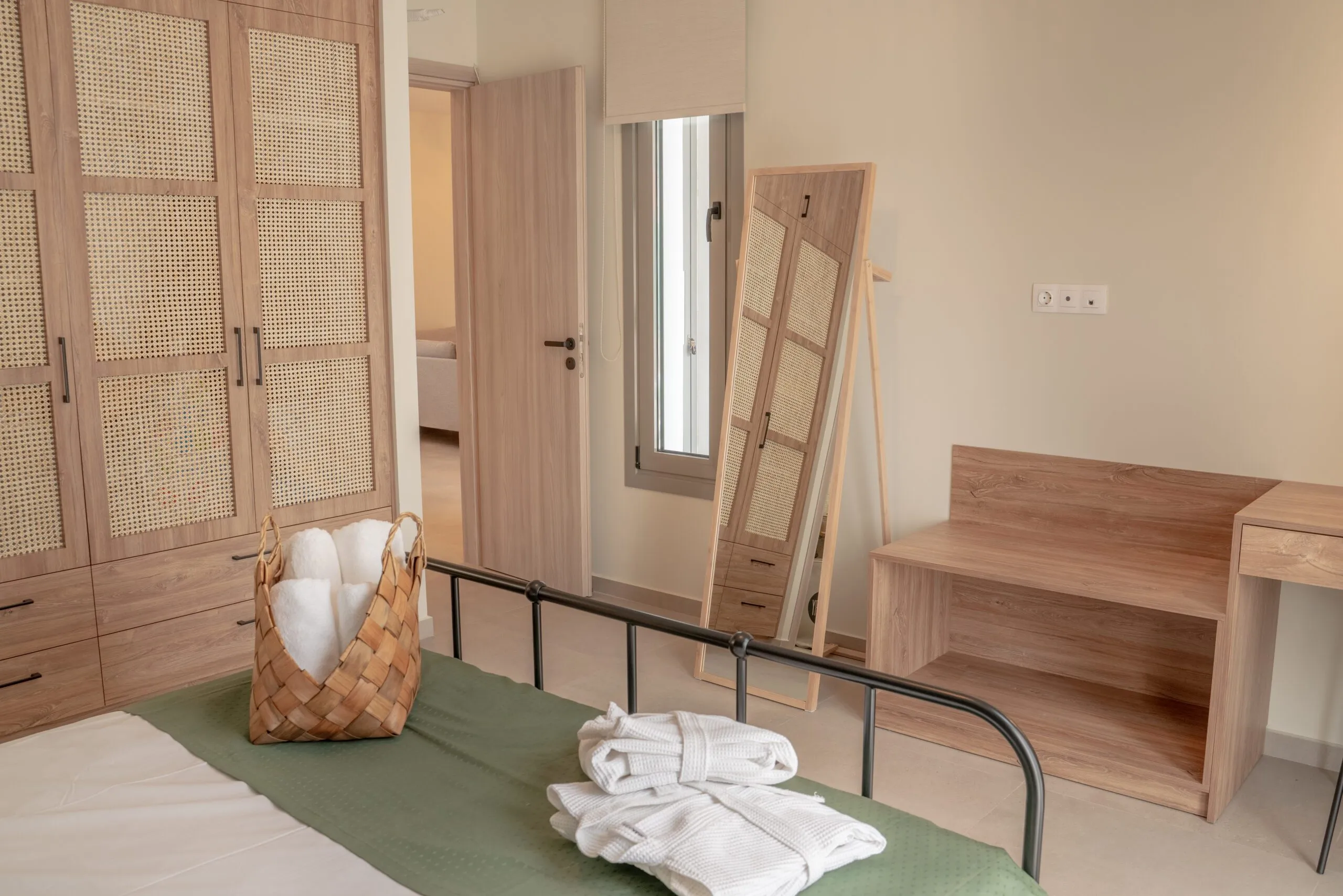 Bedroom with towels and bathrobes laid out