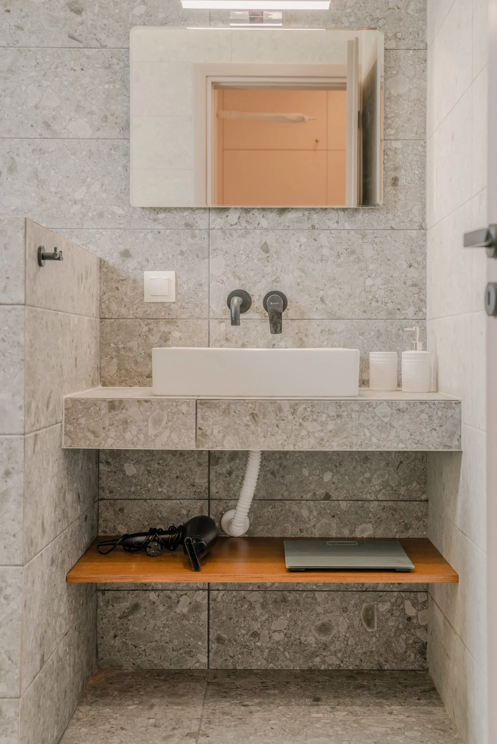 Terrazzo bathroom vanity with hair dryer